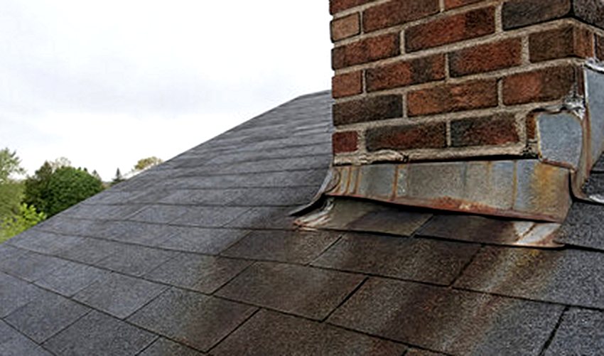 Rust streaks running from chimney flashing as proof of a failing seam