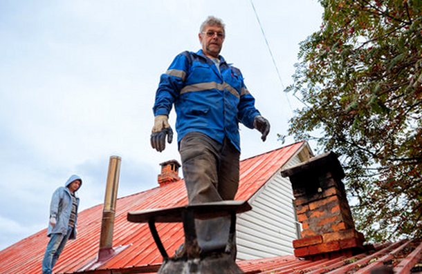 Two crew members reviewing a roofline together